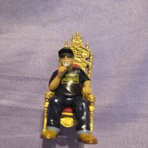 Gold and Black Toy Figure on Throne